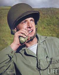Soldier puling a grenade pin with his teeth.